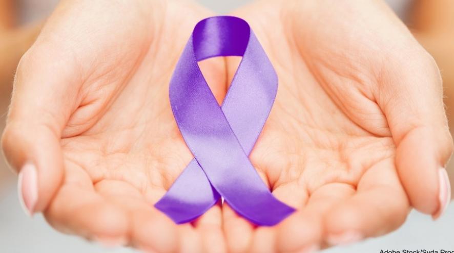 Hands holding a purple awareness ribbon.
