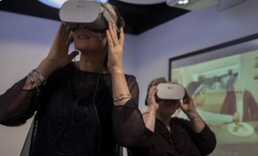 Staff wearing Virtual Reality headsets during a workshop