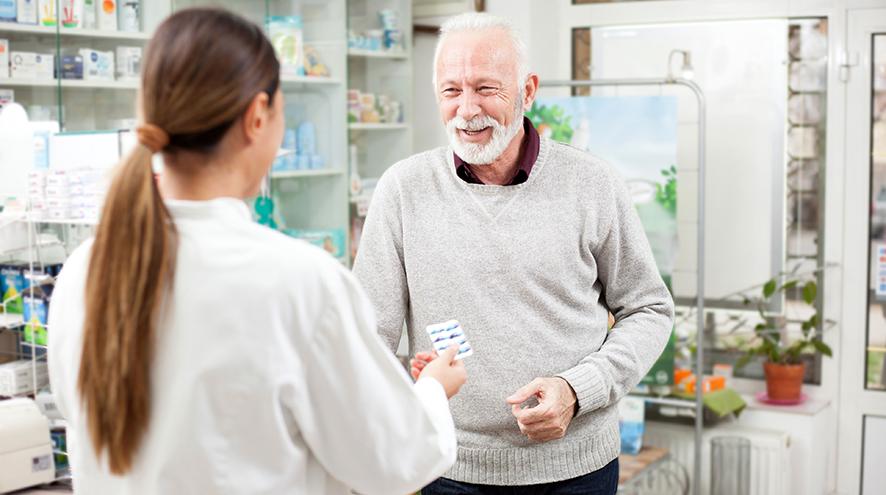 Pharmacist helping a senior client.