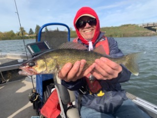 Hugh Kerr holding a fish on a boat