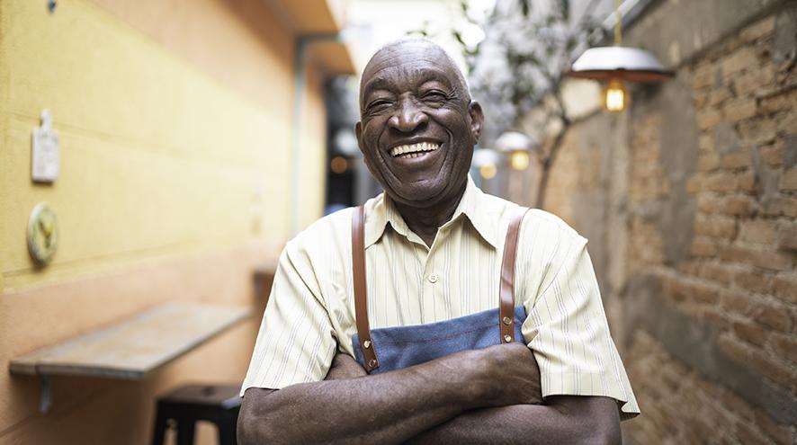 smiling senior man standing in laneway