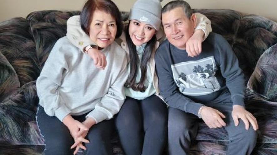 A daughter hugging mom and dad