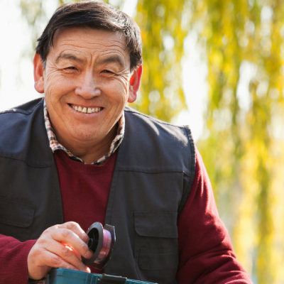 man smiling and holding a fishing rod