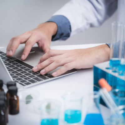 A medical researcher typing on a computer