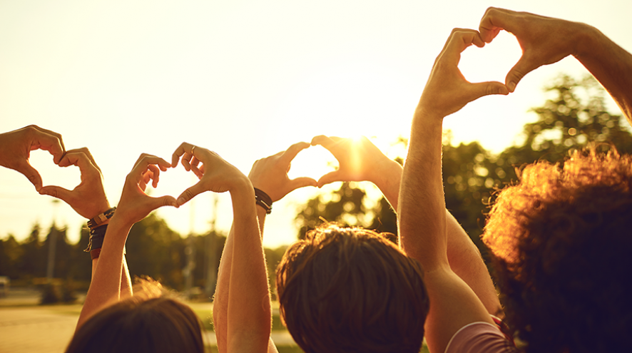 Picture of hands forming a heart shape pointing toward the sky.