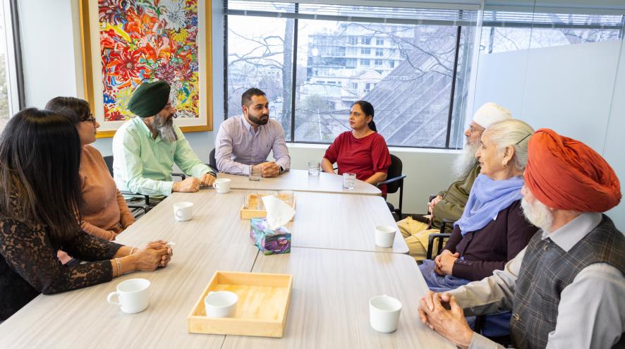 A group of caregivers sat around at a support group.