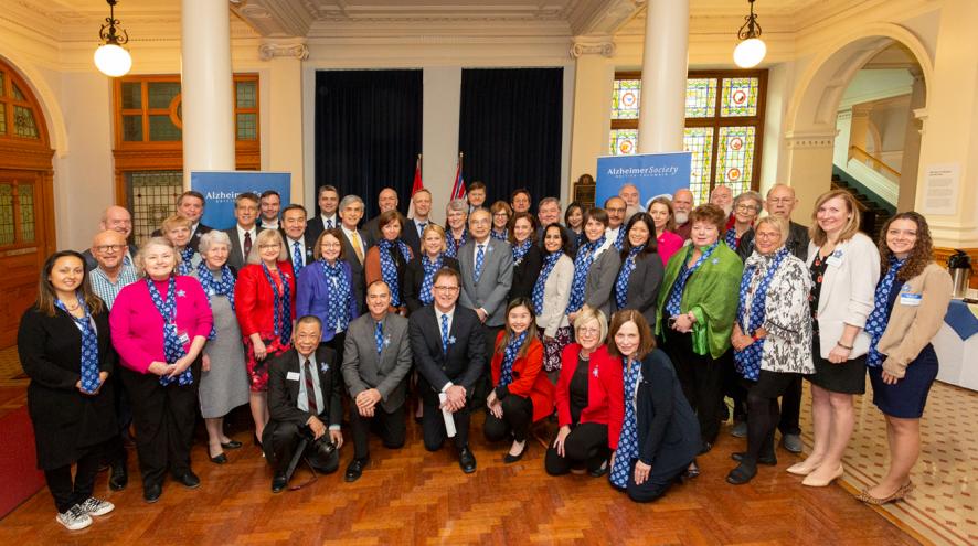 Society staff and volunteers pose for a group photo with members of B.C.'s Legislative Assembly.