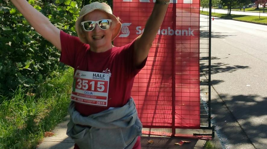 Delia with her arms in the air, celebrating the end of the race.