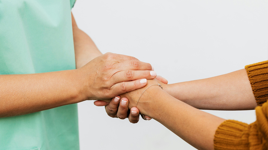 a health-care provider holding hands