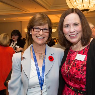 Barbara smiling and posing at a Society event.