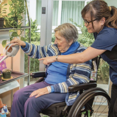 Home care aid helping woman