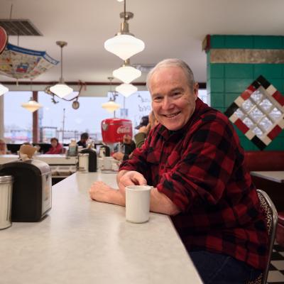 Fred Keating sitting at a booth at Bobby Sox Diner