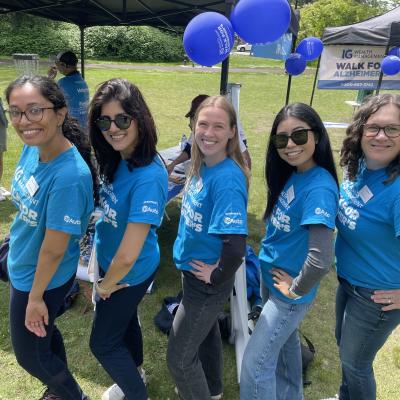 Five people in Walk for Alzheimer's t-shirts displaying the GoAuto logo on the sleeve