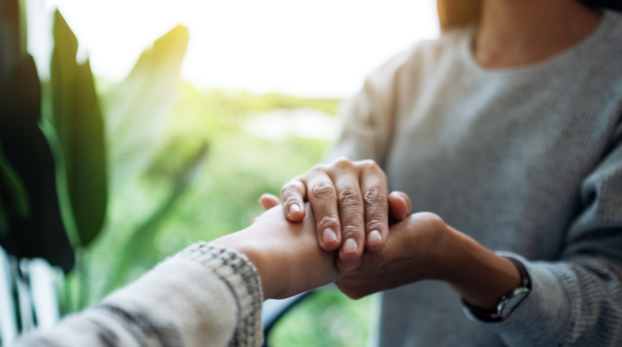 Two people holding hands