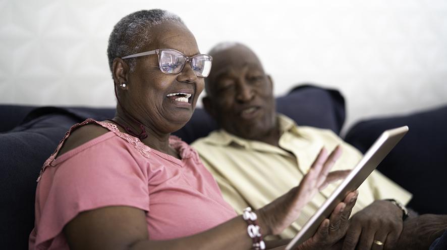 Senior couple checking their tablet together.