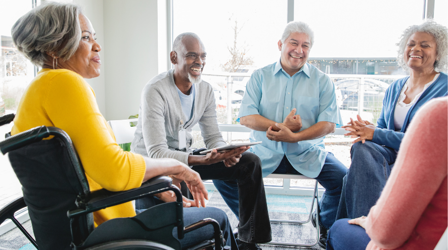 Four people sitting in circle talking