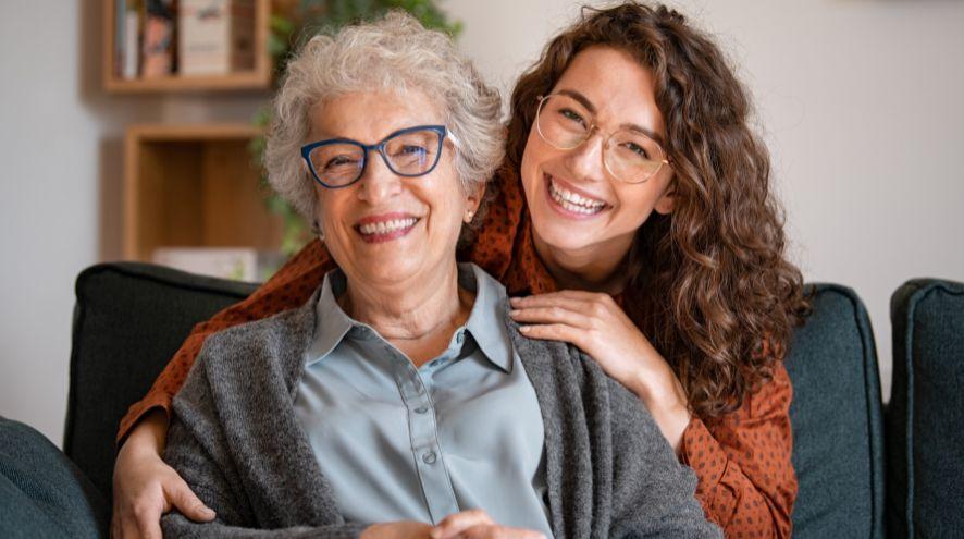 a brown-haired woman holding the arms of another woman