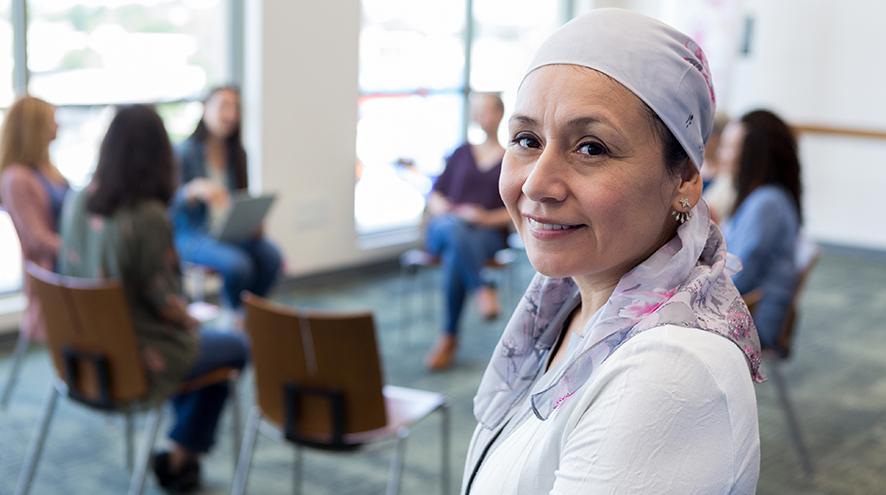 Woman smiling in front of support group.