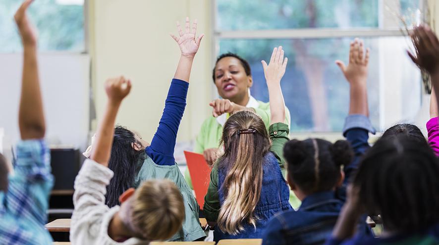 Elementary school teacher engaged with her class.