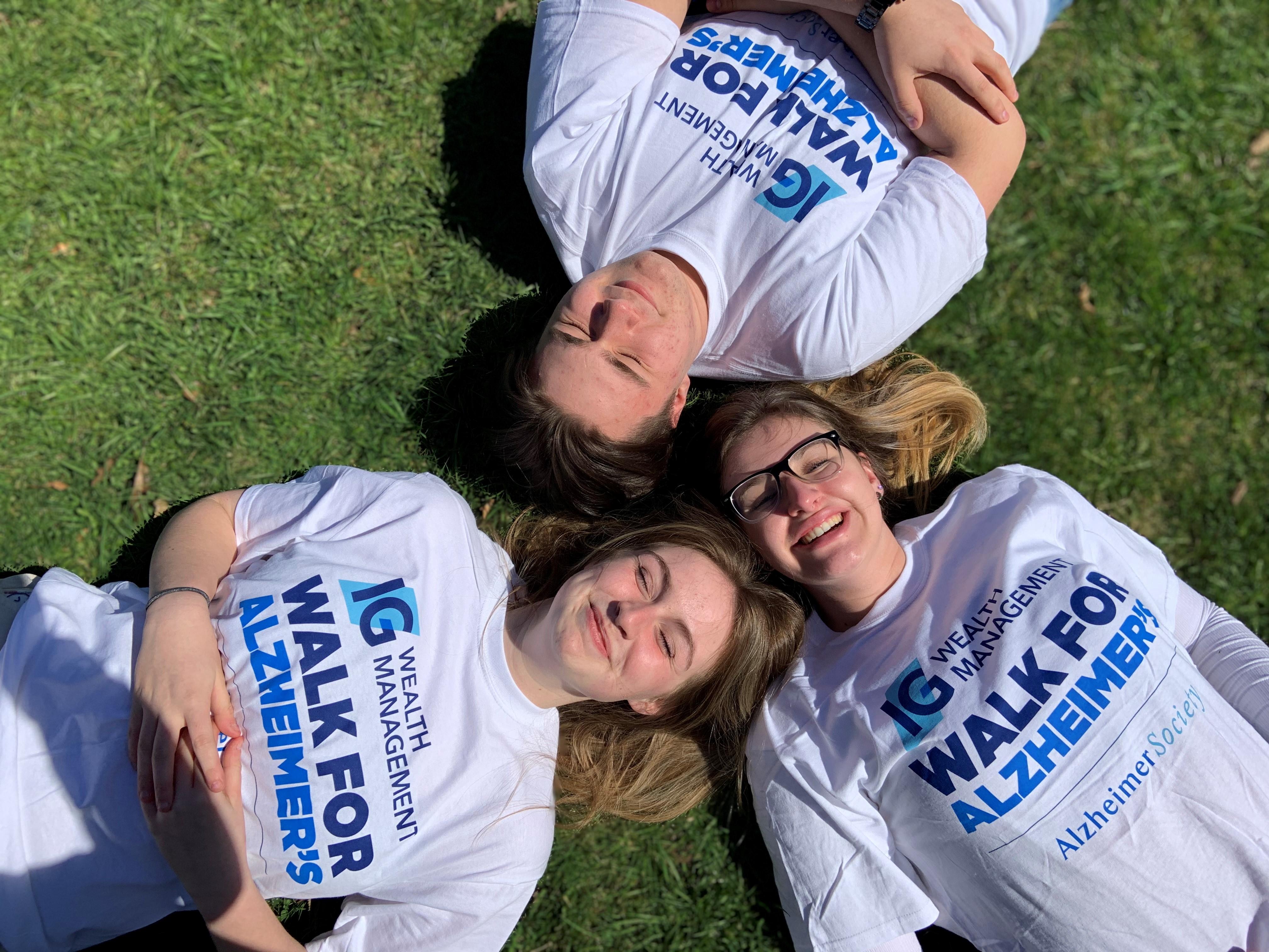 Friends lying down in the grass together at the IG Wealth Management Walk for Alzheimer's.