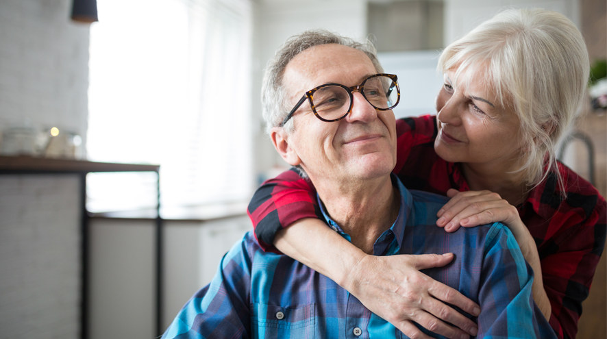 Older woman has arm around older man