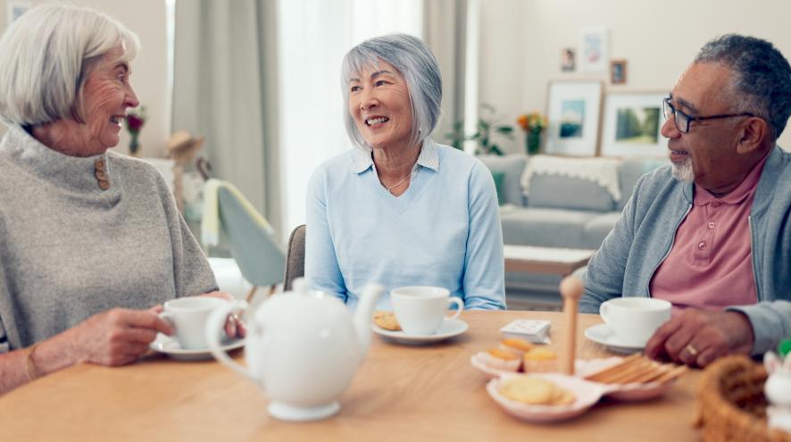Group of seniors having a conversation while drinking tea