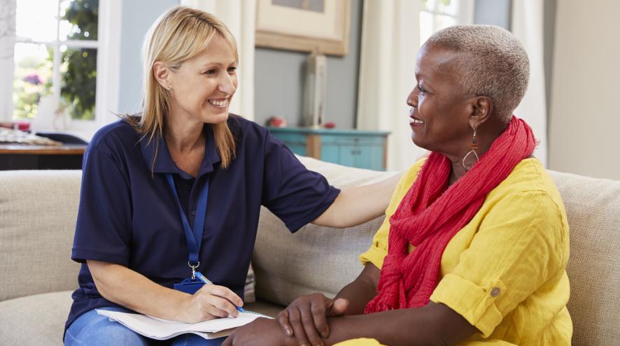 two women sitting on a couch talking