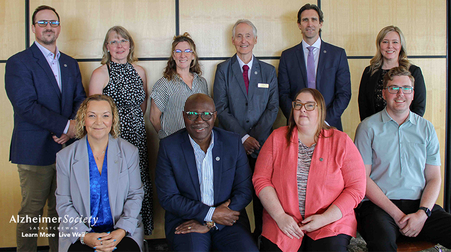 Our Board of Directors are arranged in two rows. In the back row, six people are standing and four people are sitting in the front row.