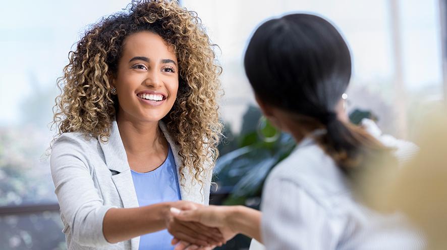 Young woman greets colleague